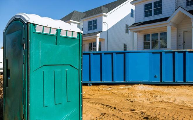 portable toilet and dumpster at a construction site in Lakewood WA